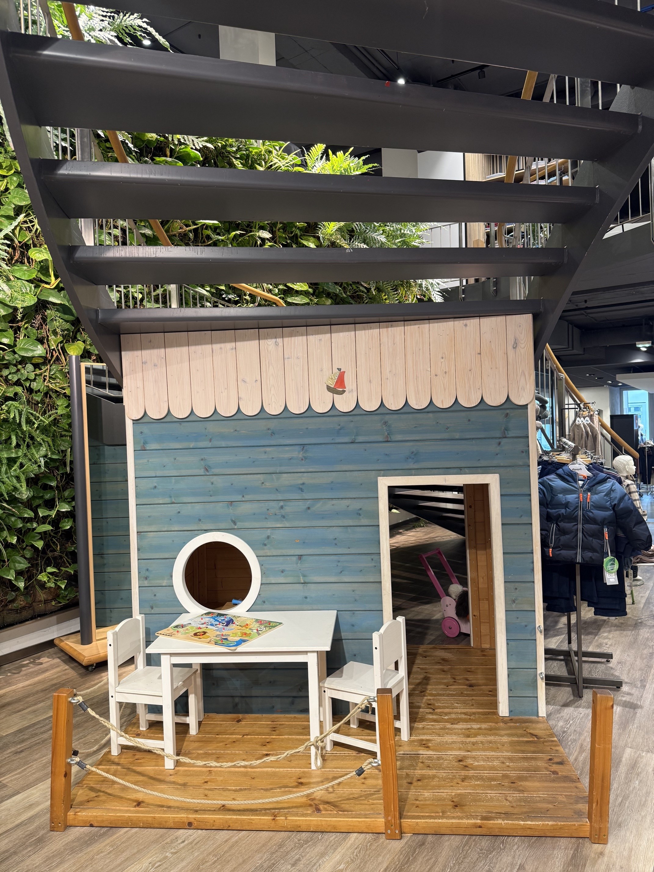 Blick in die Kinderabteilung mit Spielhaus und Kinderbekleidung